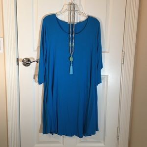 Blue jersey dress. Necklace sold separately.